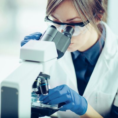 Young-scientist-looking-through-a-microscope-in-a-laboratory.-Young-scientist-doing-some-research.-667015964_2217x1357